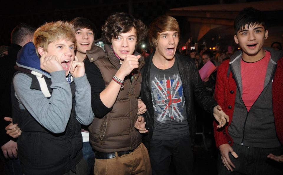2010: Niall Horan, Louis Tomlinson, Harry Styles, Liam Payne and Zayn Malik arrive for an autograph signing session at the HMV store, Bradford (PA )