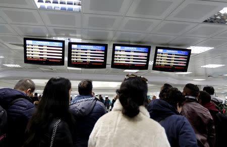 Passengers look at information boards at the Tunis airport during a nationwide strike in Tunis, Tunisia January 17, 2019. REUTERS/Zoubeir Souissi
