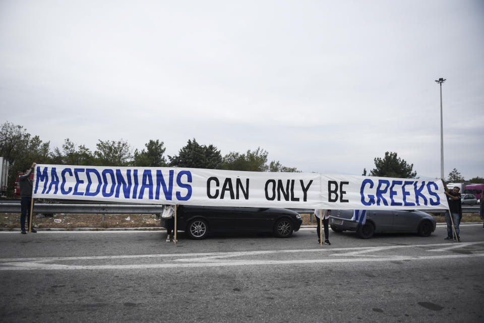 Greek protesters hold a banner during a rally against Greece's name deal with neighboring Macedonia, near Evzonoi border crossing in Greece, Sunday, Sept. 30, 2018. Macedonians were deciding on their country's future Sunday, voting whether to accept a landmark deal ending a decades-long dispute with neighboring Greece by changing their country's name to North Macedonia. (AP Photo/Giannis Papanikos)