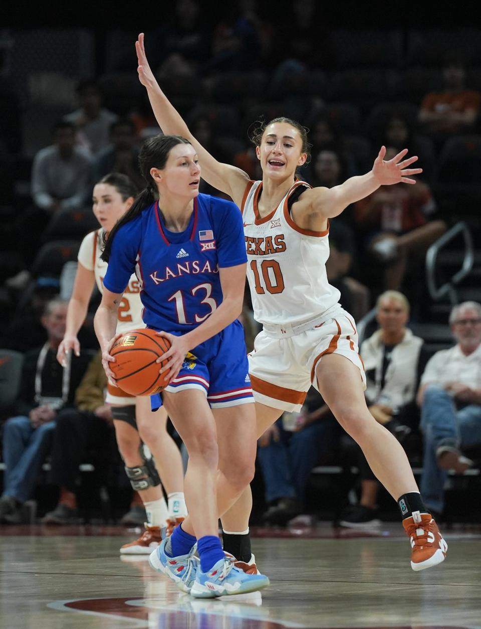 Texas guard Shay Holle applies defensive pressure to Kansas' Holly Kersgieter during the Longhorns' 72-59 win at Moody Center on Jan. 10. The Longhorns, now No. 24 in the country, will play at Kansas on Saturday.