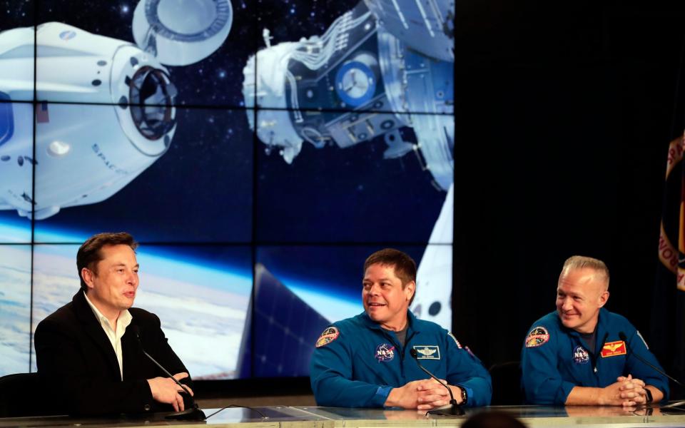 Elon Musk, left, CEO of SpaceX, speaks accompanied by NASA astronauts Bob Behnken, center, and Doug Hurley during a news conference - John Raoux /AP