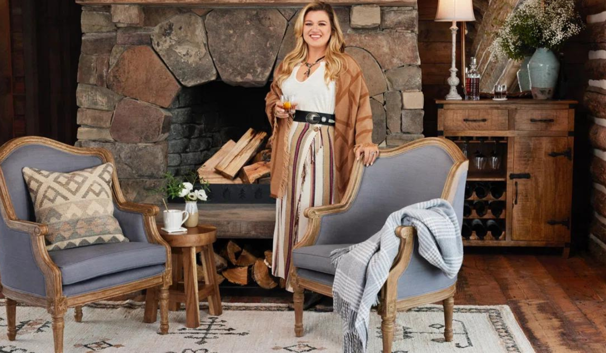 Kelly Clarkson in home with two chairs, rug and more