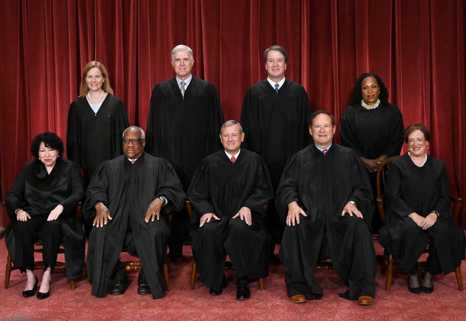 (FILES) Justices of the US Supreme Court (from left) Associate Justice Sonia Sotomayor, Associate Justice Clarence Thomas, Chief Justice John Roberts, Associate Justice Samuel Alito and Associate Justice Elena Kagan, (Standing behind from left) Associate Justice Amy Coney Barrett, Associate Justice Neil Gorsuch, Associate Justice Brett Kavanaugh and Associate Justice Ketanji Brown Jackson, pose for their official photo at the Supreme Court in Washington, DC, on October 7, 2022. The US Supreme Court unveiled an ethics code on November 13, 2023, following a series of scandals over lavish gifts and luxury vacations received by some of its justices. The nine members of the nation's highest court are the only federal judges not explicitly subject to ethical oversight, and pressure has been mounting from Democrats in the Senate for them to adopt a code of conduct. (Photo by OLIVIER DOULIERY / AFP) (Photo by OLIVIER DOULIERY/AFP via Getty Images) ORIG FILE ID: AFP_343E4EL.jpg