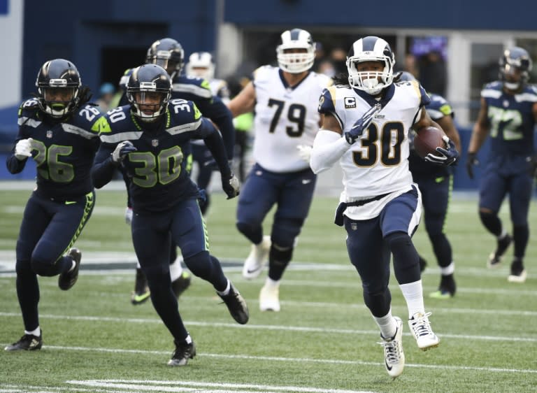 Todd Gurley (R) ran for three touchdowns and caught a scoring pass as the Los Angeles Rams took control of the NFC West with a 42-7 rout of the Seahawks