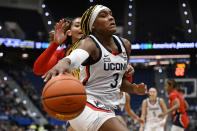 UConn forward Aaliyah Edwards (3) drives toward the basket as Dayton forward Mariah Perez defends in the first half of an NCAA college basketball game, Wednesday, Nov. 8, 2023, in Storrs, Conn. (AP Photo/Jessica Hill)