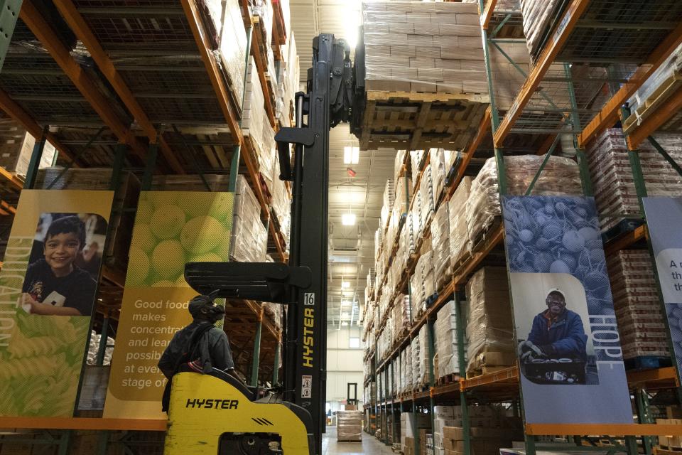 A worker loads the warehouse with food items at The Capital Area Food Bank, Tuesday, Oct. 5, 2021, in Washington. (AP Photo/Jacquelyn Martin)