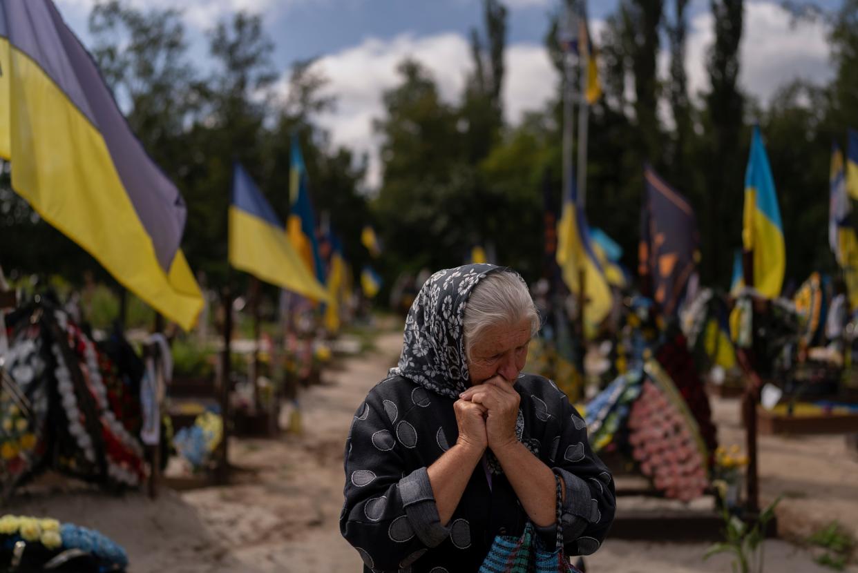 Svitlana Sushko, 62, sobs while visiting the grave of her youngest son, a Ukrainian soldier who was killed last year in the war against Russia, in Kyiv (AP)