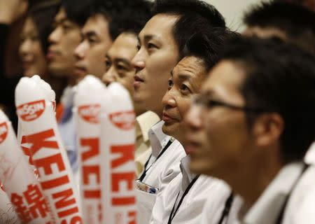 Employees of Japanese instant-noodle maker Nissin Foods Holdings, which sponsors Kei Nishikori of Japan, watch the final of the U.S. Open tennis tournament match between Nishikori and Marin Cilic of Croatia during a public viewing event at the company in Tokyo September 9, 2014. REUTERS/Yuya Shino