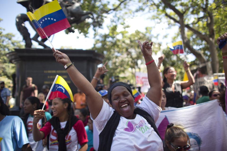 Supporters of President Nicolas Maduro sing a song about Venezuela's late president Hugo Chavez, during a event at Bolivar Square in Caracas, Venezuela, Thursday, Feb. 7, 2019. Maduro said that he hopes to collect 10 million signatures to ask Washington to withdraw its threats of war against the people of Venezuela. (AP Photo/Ariana Cubillos)