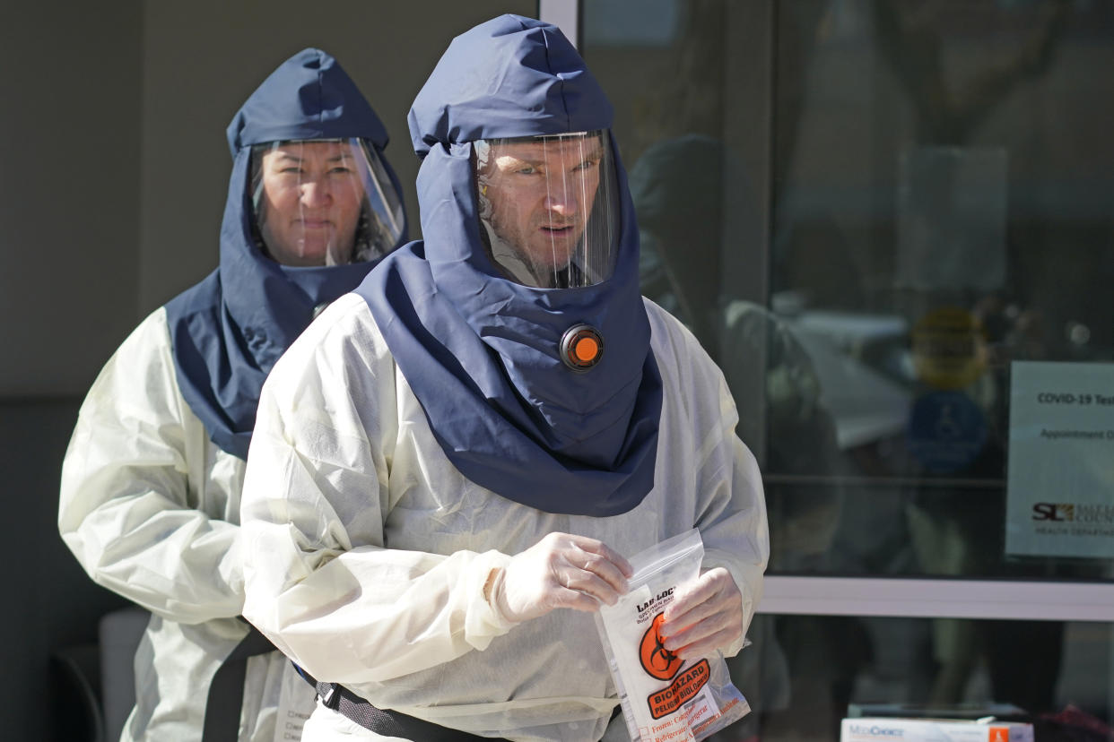 Salt Lake County Health Department public health nurses look on during coronavirus testing outside the department in Salt Lake City, Utah on Nov. 3, 2020. (Rick Bowmer/AP)                                                                                                                                                                                                                                                        