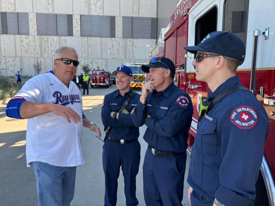 Arlington Mayor Jim Ross talked before the parade with firefighters Zach waters, Mike Joiner and Drew Hanson. Bud Kennedy/bkennedy@star-telegram.com