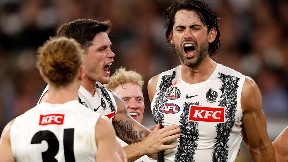 Collingwood's Brodie Grundy celebrates a goal against the Essendon Bombers.