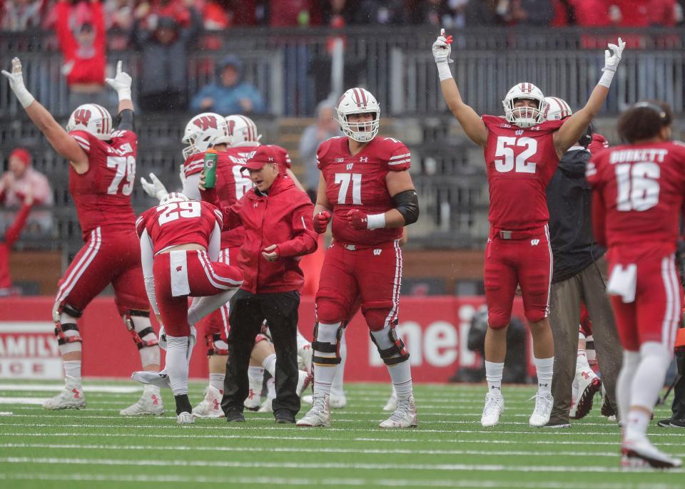 Wisconsin offensive lineman Riley Mahlman (71) and linebacker Kaden Johnson (52) celebrate after a replay review confirms a Badgers touchdown against Maryland on Saturday, Nov. 5, 2022, at Camp Randall Stadium in Madison.