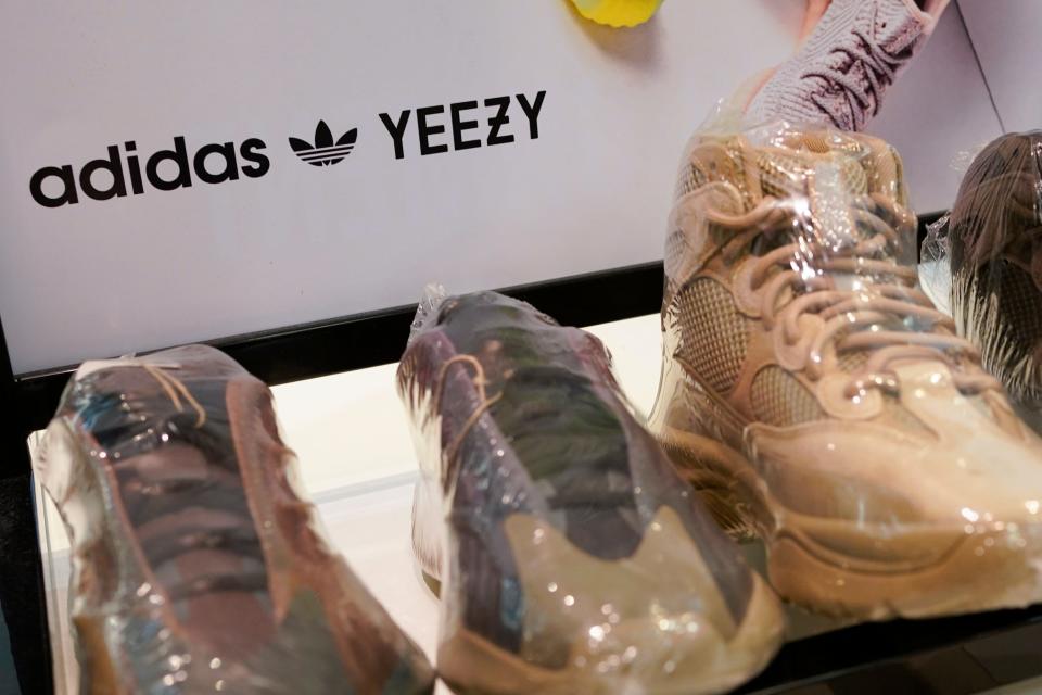 A sign advertises Yeezy shoes made by Adidas at Kickclusive, a sneaker resale store, in Paramus, N.J., Tuesday, Oct. 25, 2022. Adidas is one of several companies to end its partnership with the rapper formerly known as Kanye West over his offensive and antisemitic remarks.