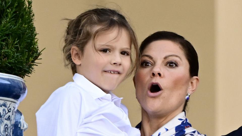 Prince Alexander being held up by Crown Princess Victoria