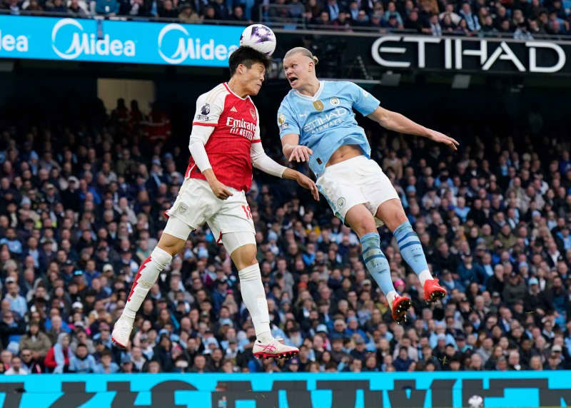 Arsenal's Takehiro Tomiyasu (L) and Manchester City's Erling Haaland battle for the ball during the English Premier League soccer match between Manchester City and Arsenal at the Etihad Stadium. Andrew Yates/CSM via ZUMA Press Wire/dpa