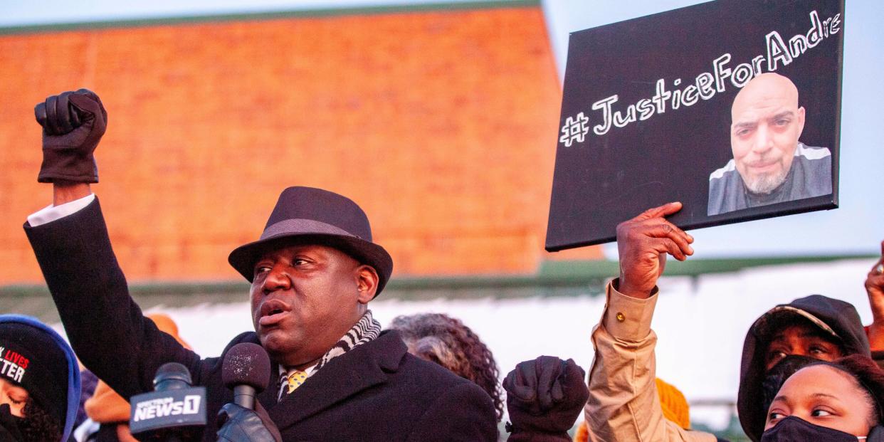 Attorney Ben Crump raises his fist as he addresses the crowd during a press conference and candlelight vigil for Andre Hill outside the Brentnell Community Recreation Center in Columbus, Ohio on December 26, 2020.