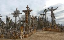 <p>On the outskirts of <em>Šiauliai</em>, in northern Lithuania, sits an ominous looking outcropping filled with crosses large and small, simple and ornate. The <a rel="nofollow noopener" href="http://www.hillofcrosses.com/" target="_blank" data-ylk="slk:Hill of Crosses;elm:context_link;itc:0;sec:content-canvas" class="link ">Hill of Crosses</a> began in the wake of a rebellion against the Russian tsar that left hundreds dead. Relatives of the fallen rebels had no bodies to bury, so instead they left crosses to mark the passing of their loved ones. During Communist rule when religion was forbidden, the tradition continued under the cover of night, with people marking losses and making prayers at the crosses. Now more than 200,000 crosses fill the site, along with rosaries, pictures of saints, and handwritten prayers. It makes for an eerie place, despite the Pope’s sentiment that the Hill of Crosses was a place for hope, peace, love, and sacrifice.</p>