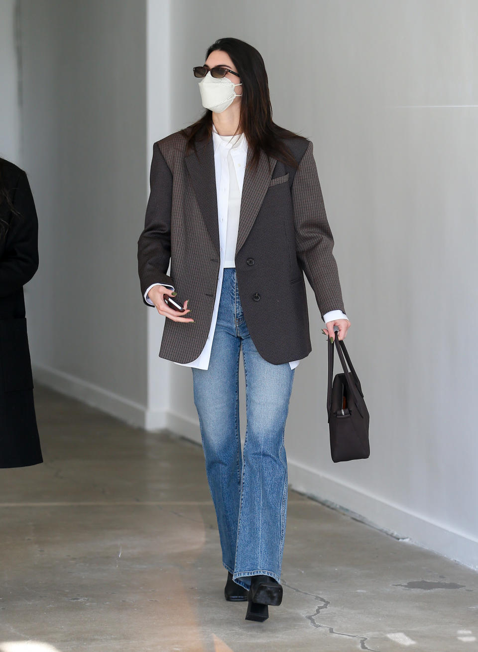 kendall jenner in brown blazer and blue jeans and white shirt