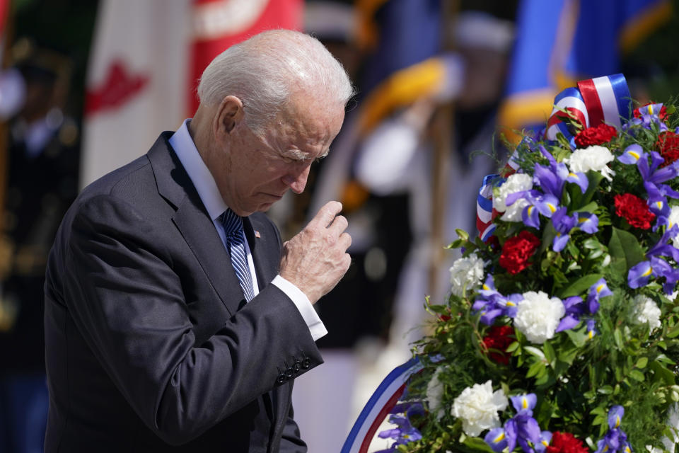 President Joe Biden makes the sign of the cross as he places a wreath at the Tomb of the Unknown Soldier at Arlington National Cemetery on Memorial Day, Monday, May 31, 2021, in Arlington, Va.(AP Photo/Alex Brandon)