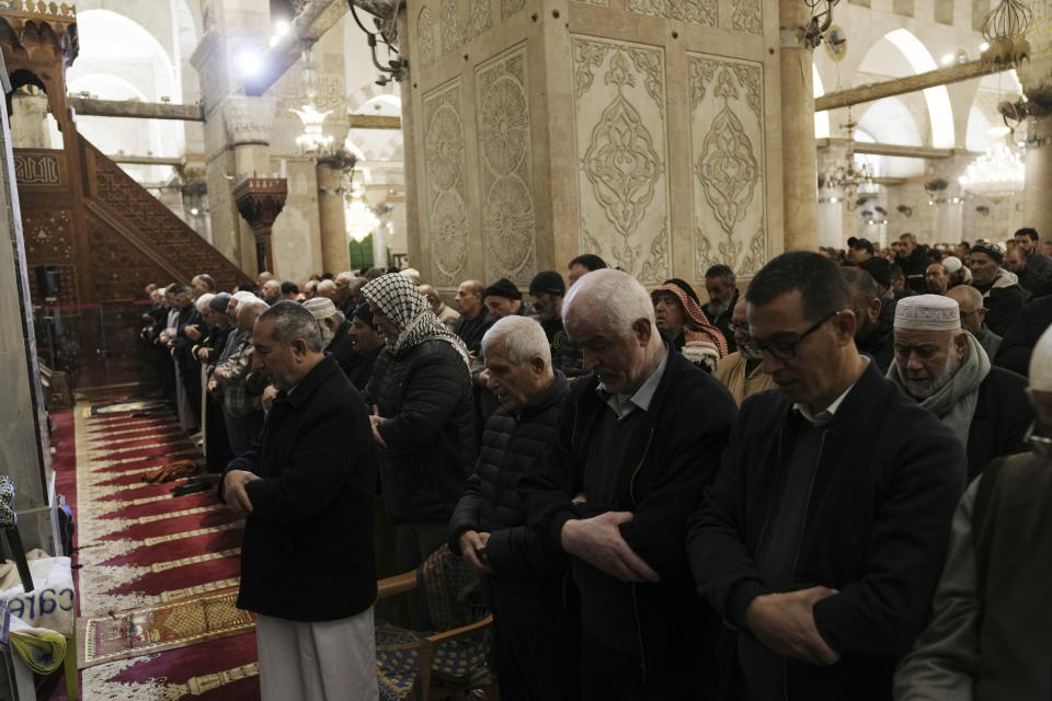 Palestinian worshippers pray during the Muslim holy month of Ramadan in the Al-Aqsa Mosque compound following a raid by Israeli police in the Old City of Jerusalem, Wednesday, April 5, 2023. Palestinian media reported police attacked Palestinian worshippers, raising fears of wider tension as Islamic and Jewish holidays overlap.(AP Photo/Mahmoud Illean)