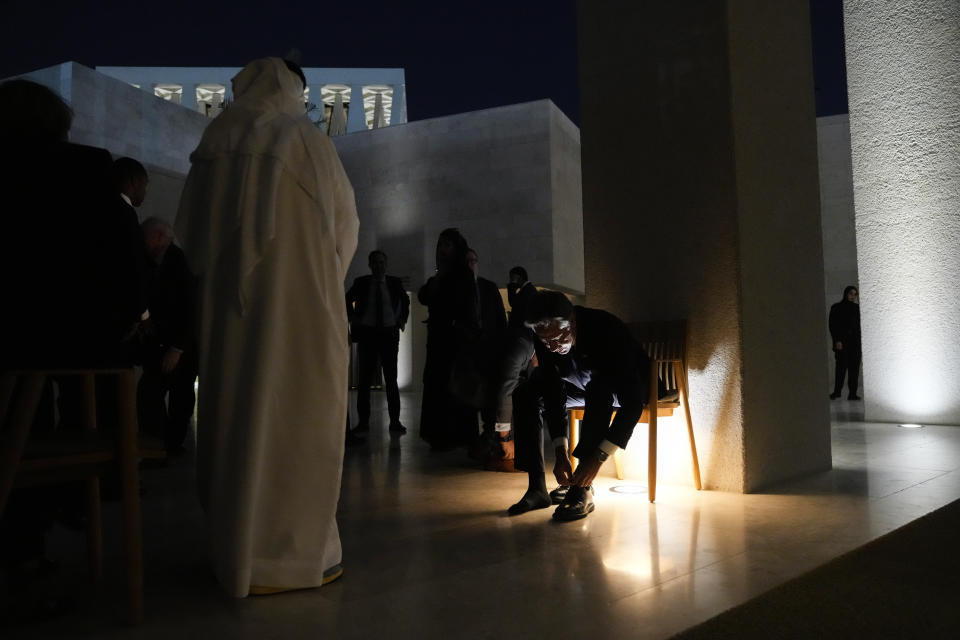 FILE - Secretary of State Antony Blinken puts his shoes on after touring the Imam Al-Tayeb Mosque at the Abrahamic Family House, in Abu Dhabi, United Arab Emirates, Oct. 14, 2023. AP Washington photographer Jacquelyn Martin recalls how being one of a few female photographers covering news and politics was useful when she was assigned as the press pooler for Blinken's last-minute trip to Israel and the Middle East in the aftermath of the Hamas attacks. Martin said, “Sometimes people not knowing what to make of you works in your favor.” (AP Photo/Jacquelyn Martin, Pool, File)