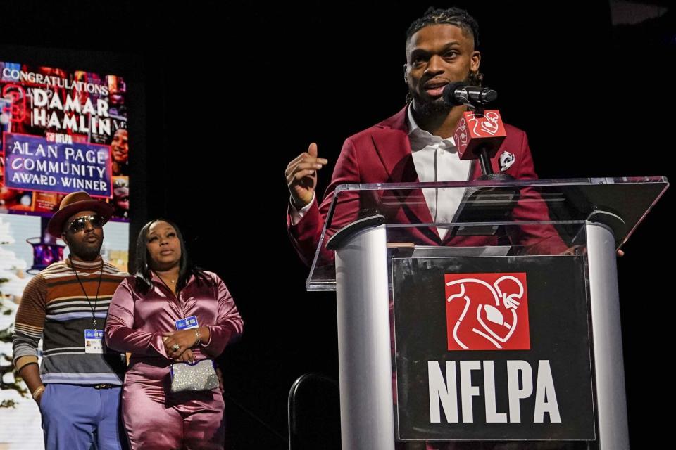 Buffalo Bills' Damar Hamlin, right, speaks after being introduced as the winner of the Alan Page Community Award during a news conference ahead of the Super Bowl 57 NFL football game, in Phoenix. At left looking on are Damar Hamlin's parents Mario and Nina Hamlin Super Bowl Football, Phoenix, United States - 08 Feb 2023