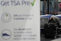 A traveler talks on the phone at the O'Hare International Airport in Chicago, Thursday, Dec. 21, 2023. It's beginning to look a lot like a hectic holiday travel season, but it might go relatively smoothly if the weather cooperates. (AP Photo/Nam Y. Huh)