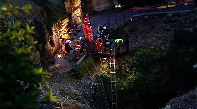 Rescue crews attempting to coax the pair out of the sinkhole, yesterday evening.