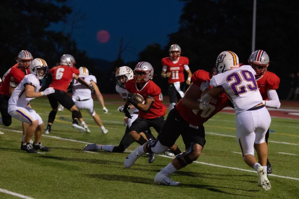 Somers' Ravi Dass runs with the ball at a John Jay vs Somers Football Game at Somers High School.