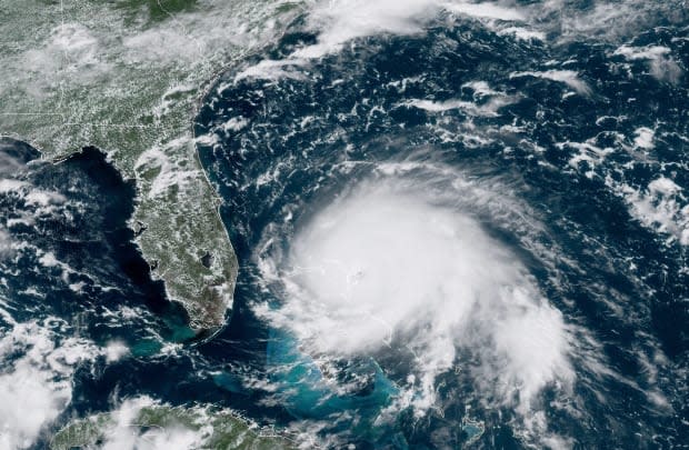 This satellite image shows Hurricane Dorian over the Bahamas on Sept. 1, 2019. It struck the islands as a Category 5 hurricane, levelling homes and buildings and causing widespread flooding.  (NOAA/The Associated Press - image credit)