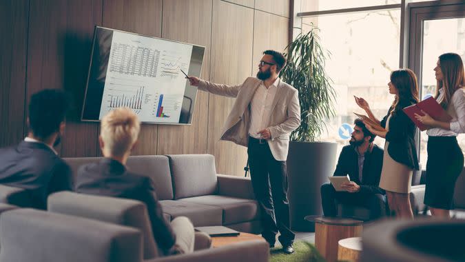 Business team on a morning briefing; business meeting and presentation in a modern office.