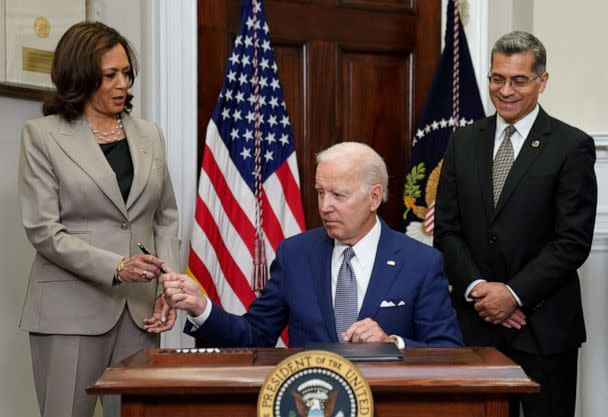 PHOTO: President Joe Biden hands the pen to Vice President Kamala Harris after signing an executive order at the White House in Washington, July 8, 2022. (Kevin Lamarque/Reuters, FILE)