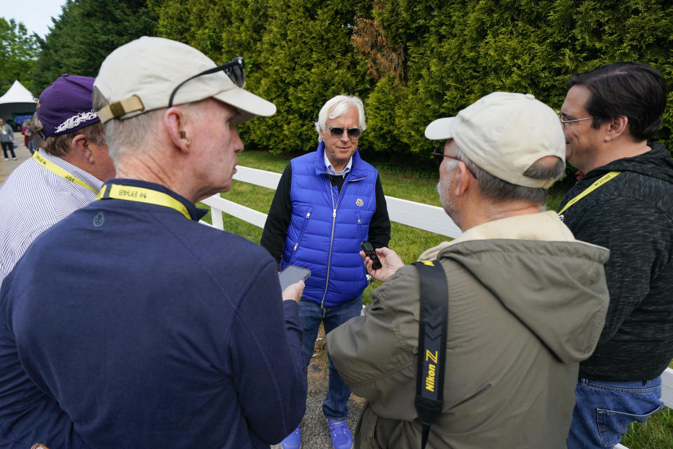 Bob Baffert, center, owner of Preakness Stakes entrant National Treasure, speaks to reporters ahead of the 148th running of the Preakness Stakes horse race at Pimlico Race Course, Friday, May 19, 2023, in Baltimore. (AP Photo/Julio Cortez)