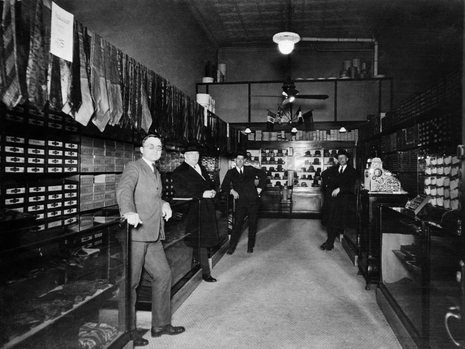 Harry S. Truman, shown in foreground, inside his Kansas City men's shop.