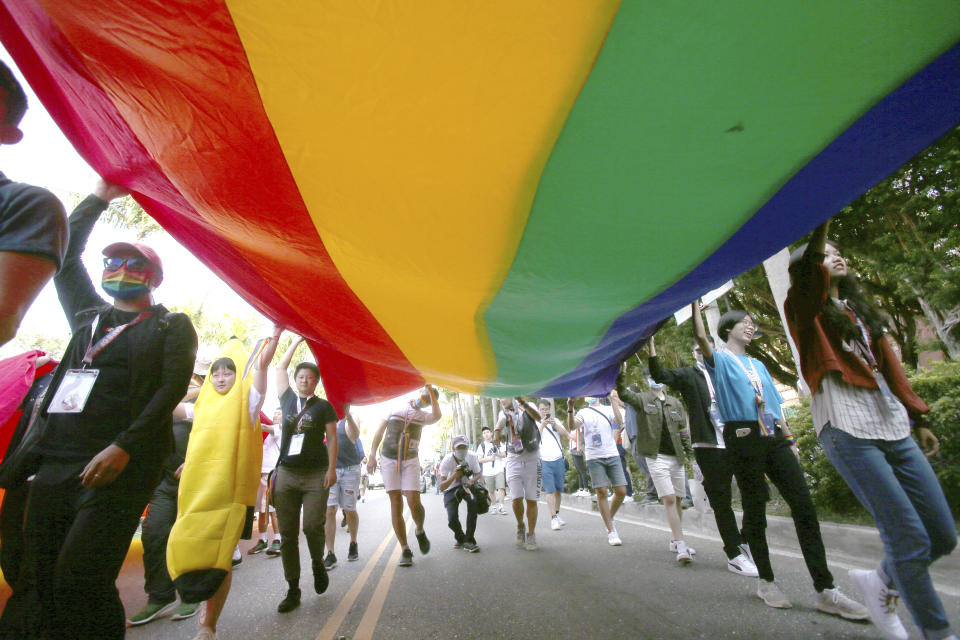 Participants march through a street during a pride parade in Taipei, Taiwan, Saturday, Oct. 31, 2020. (AP Photo/Chiang Ying-ying)