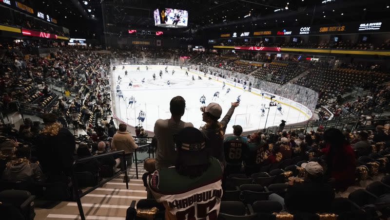 Fans watch players as they warm up prior to the Arizona Coyotes NHL home opening hockey game against the Winnipeg Jets at the 5,000-seat Mullett Arena in Tempe, Ariz., on Oct. 28, 2022.