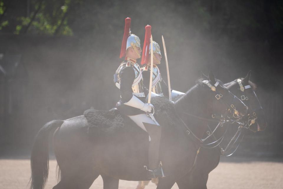 Members of the Household Cavalry kick up the dust as they ride across Horse Guards Parade, London (Dominic Lipinski/PA) (PA Wire)