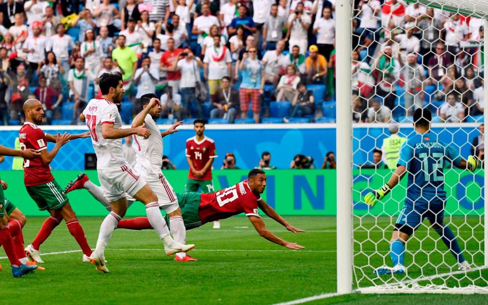 Aziz Bouhaddouz (C) scores an own goal to give Iran a 1-0 win - AFP