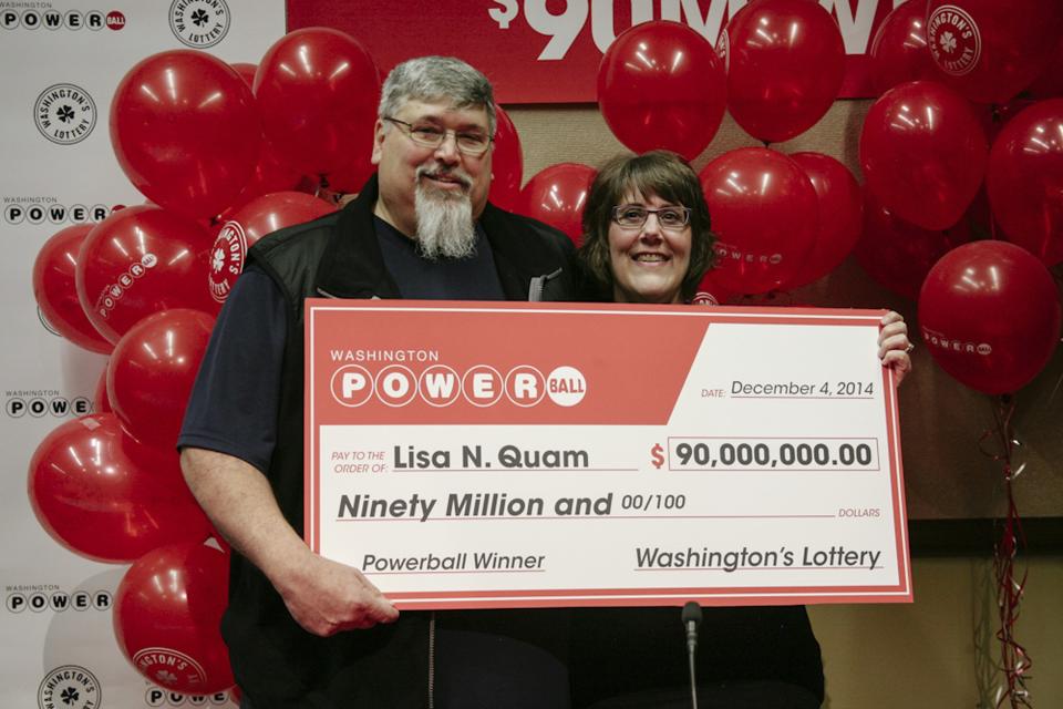 Lisa Quam and her husband Everett hold a check for $90 million during a news conference in Olympia, Washington December 4, 2014 in this handout picture provided by the Washington State lottery. Lisa Quam on Thursday claimed a $90 million Powerball lottery jackpot after buying a ticket for the first time, and said she would quit her job at plane maker Boeing Co and buy a new Subaru. REUTERS/Washington State Lottery/Handout (UNITED STATES - Tags: SOCIETY TPX IMAGES OF THE DAY) ATTENTION EDITORS - THIS PICTURE WAS PROVIDED BY A THIRD PARTY. REUTERS IS UNABLE TO INDEPENDENTLY VERIFY THE AUTHENTICITY, CONTENT, LOCATION OR DATE OF THIS IMAGE. FOR EDITORIAL USE ONLY. NOT FOR SALE FOR MARKETING OR ADVERTISING CAMPAIGNS. NO SALES. NO ARCHIVES. THIS PICTURE IS DISTRIBUTED EXACTLY AS RECEIVED BY REUTERS, AS A SERVICE TO CLIENTS