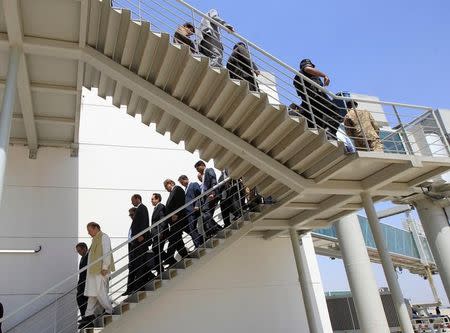 Pakistani Prime Minister Nawaz Sharif leads a delegation as they walk down stairs from the terminal to the tarmac at the newly built airport in Islamabad, Pakistan May 6, 2017. REUTERS/Caren Firouz