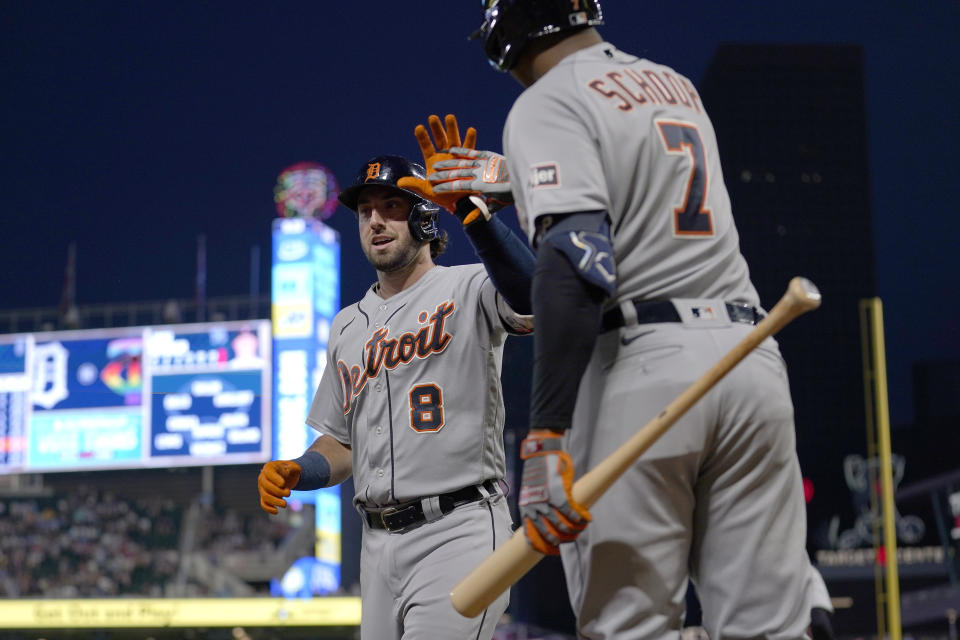Detroit Tigers' Matt Vierling (8) celebrates with Jonathan Schoop (7) after hitting as solo home run during the ninth inning of a baseball game against the Minnesota Twins, Friday, June 16, 2023, in Minneapolis. (AP Photo/Abbie Parr)