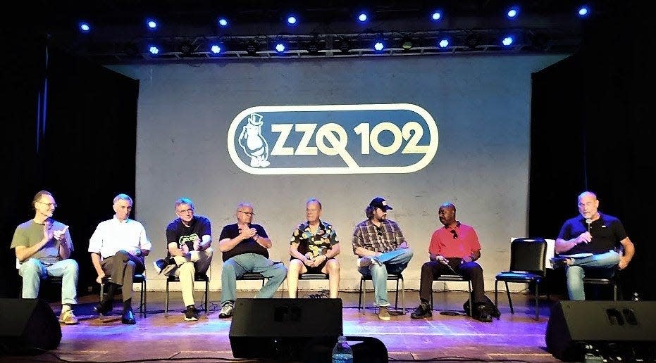 Appearing as panelists on stage at Duling Hall in August of 2022 for the “WZZQ Listener Event” were, from left, announcers Bill Ellison, Lamar Evans, Randy Bell, Bruce Owen, and Curtis Jones; Sam Adcock, the son of former music director David Adcock; announcer Perez Hodge; and moderator Robert St. John.