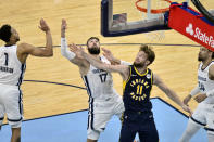 Indiana Pacers forward Domantas Sabonis (11) and Memphis Grizzlies center Jonas Valanciunas (17) reach for a rebound in the second half of an NBA basketball game Sunday, April 11, 2021, in Memphis, Tenn. (AP Photo/Brandon Dill)