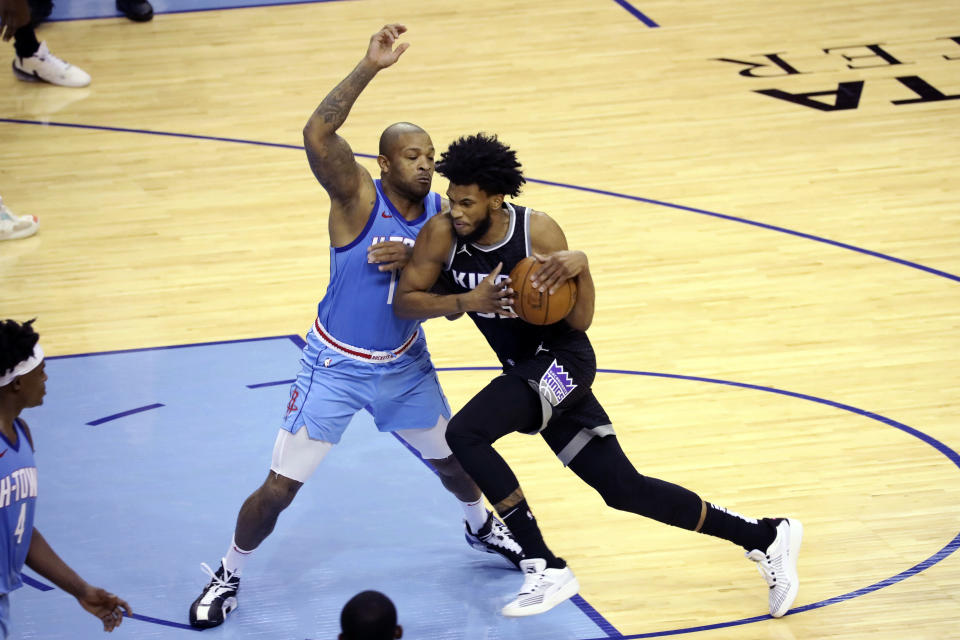 Sacramento Kings' Marvin Bagley, right, pushes past Houston Rockets' PJ Tucker during the first half of an NBA basketball game, Thursday Dec. 31, 2020, in Houston. (AP Photo/Richard Carson)