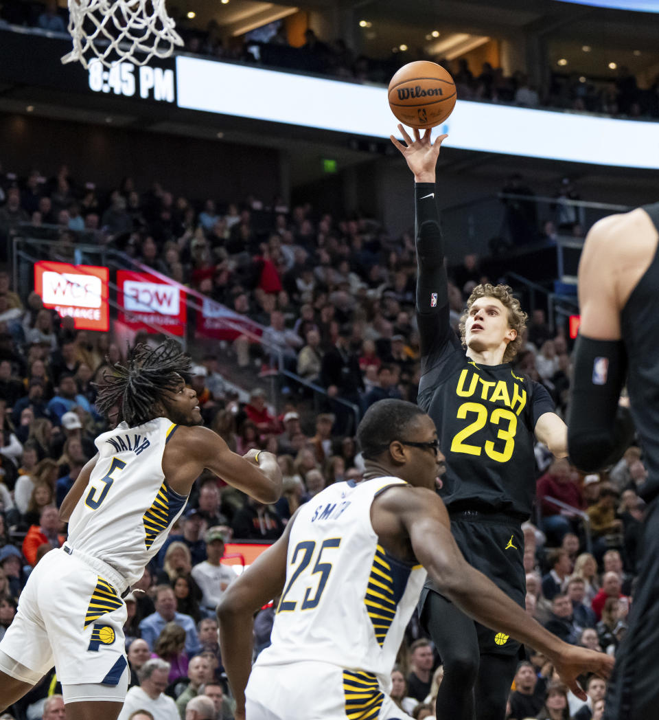 Utah Jazz forward Lauri Markkanen (23) shoots over Indiana Pacers forwards Jarace Walker (5) and Jalen Smith (25) during the second half of an NBA basketball game Monday, Jan. 15, 2024, in Salt Lake City. (AP Photo/Spenser Heaps)