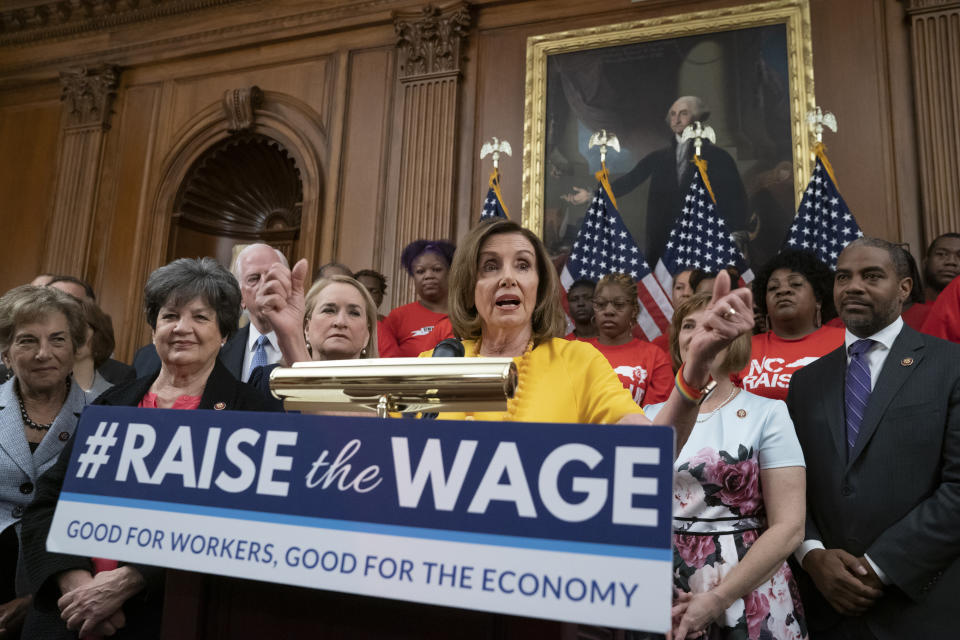 FILE - In this July 18, 2019, file photo speaker of the House Nancy Pelosi, D-Calif., joins fellow Democrats and activists seeking better pay as the House approved legislation to raise the federal minimum wage for the first time in a decade _ to $15 an hour, at the Capitol in Washington. As of Jan. 1, 2020, there are higher minimum wages in a quarter of the states, and new federal overtime rules. (AP Photo/J. Scott Applewhite, File)