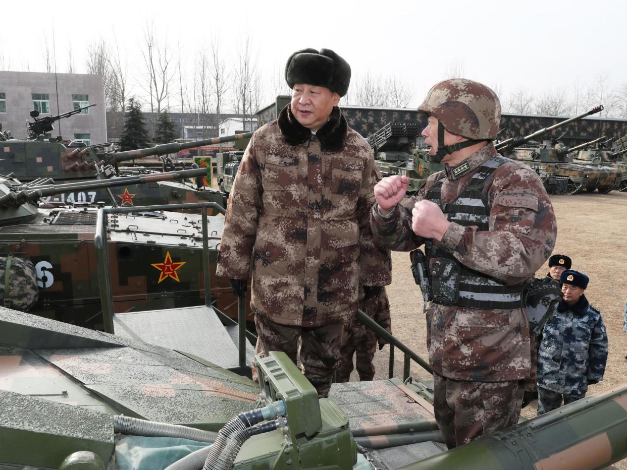 Xi Jinping (left) inspecting tanks ahead of the military parade in Heibei: Xinhua News Agency/REX