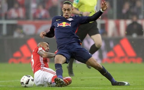 Leipzig's Yussuf Poulsen, right, and Bayern's Arturo Vidal challenge for the ball during the German Bundesliga soccer match between FC Bayern Munich and RB Leipzig at the Allianz Arena stadium in Munich - Credit: AP