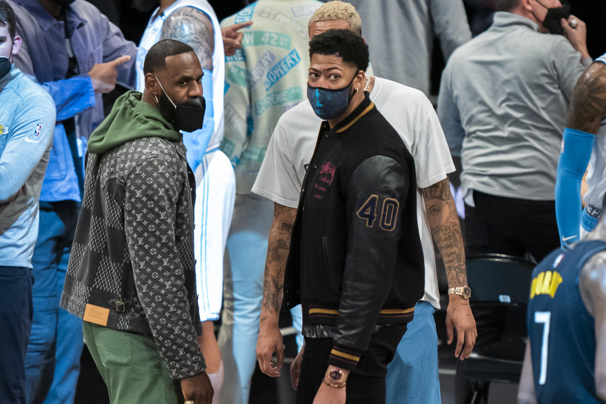 Los Angeles Lakers forward LeBron James and forward Anthony Davis look on during a time out  in the second half of an NBA basketball game against the Brooklyn Nets, Saturday, April 10, 2021, in New York. (AP Photo/Corey Sipkin)